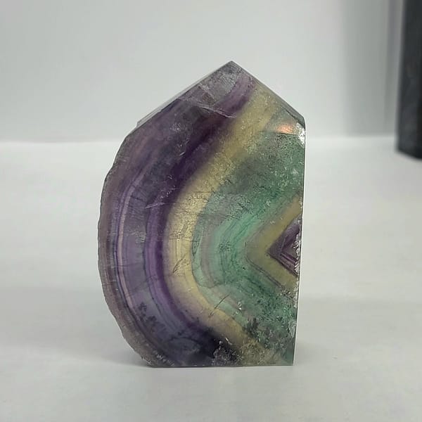 345c4a62-9ac4-5337-8edf-fbe946101d7b-1.jpg Rainbow Fluorite Polished Point -Live Edge | 2.G